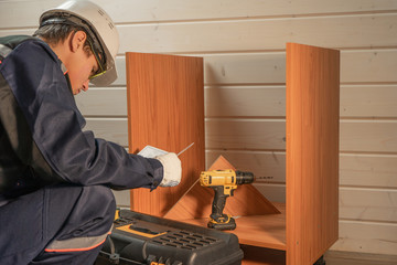 The professional collector of furniture using repair tools to build new furniture.