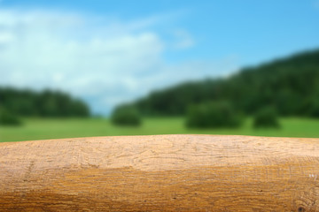 Empty wooden table on outdoor bokeh background. Summer time. Table for product design.