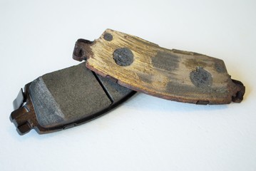Worn out ruined disc brake pad compared to one that is new © PictureThisImages