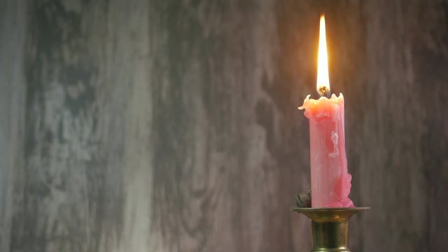 candle in a candle stick background video with copy space
