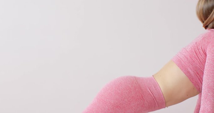 Healthy yoga woman in pink sportswear practicing cat cow pose enjoying fitness lifestyle exercising at home stretching beautiful body training on exercise mat at midday. Close up shot