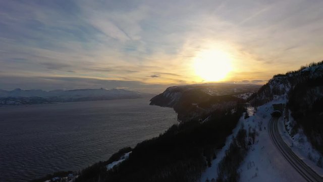 Ofotfjord Fjord and Mountains in Winter at Sunset. Nordland, Norway. Aerial View. Drone Flies Sideways and Upwards