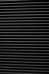 Obraz premium Thin lines of light on the wall. Shadow from the blinds. bathroom.