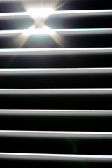 Obraz premium Thin lines of light on the wall. Shadow from the blinds. bathroom.