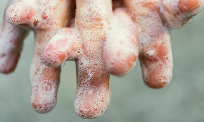 Covid - 19 Coronavirus prevention. A man wash our hands with antibacterial soap. Corona pandemic...