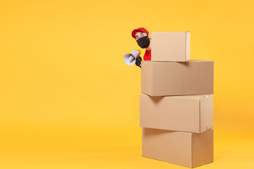 Delivery man employee in red cap blank t-shirt uniform face mask glove hold empty cardboard box isolated on yellow background studio Service quarantine pandemic coronavirus flu virus 2019-ncov concept