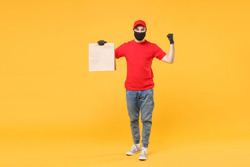 Delivery man employee in red cap blank t-shirt uniform mask glove hold craft paper packet with food isolated on yellow background studio Service quarantine pandemic coronavirus virus 2019-ncov concept