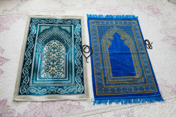 prayer rugs in two different colors prepared for prayer
