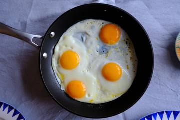 Traditional Turkish Breakfast with Sunny Side Up Eggs, Feta Cheese, Tea, Olives and Cucumber. Breakfast for two