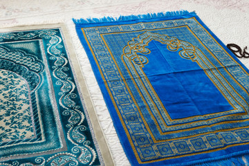 Islamic symbols, prayer rugs on a carpet in a house,