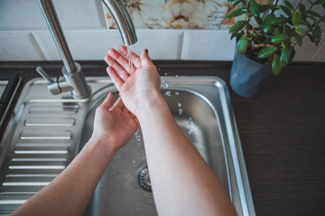 washing woman hands in bathroom