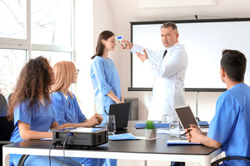 Fototapeta premium Male lecturer teaching medical students in university