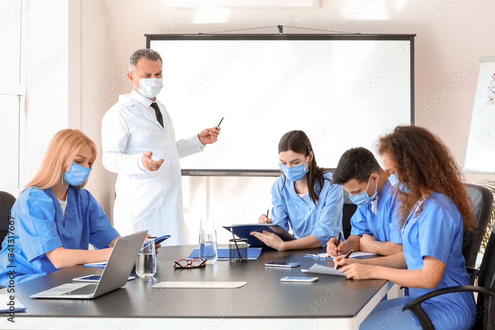 Poster Male lecturer teaching medical students in university