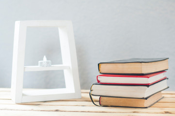 A stack of books on the table. White frame.