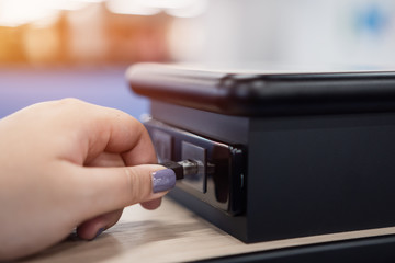 Close up woman hands tourist putting black USB port plugged in, Plugging into usb outlet plug at terminal in airport service support  for Traveler charging mobile equipment of digital power connector.