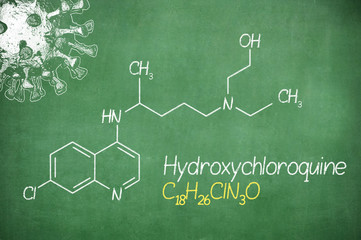 Hydroxychloroquine , chloroquine medicine substance. Drug introduced as treatment for coronavirus SARS-CoV-2. Active in COVID-19 supportive therapy. Chemical formula written with chalk on board.