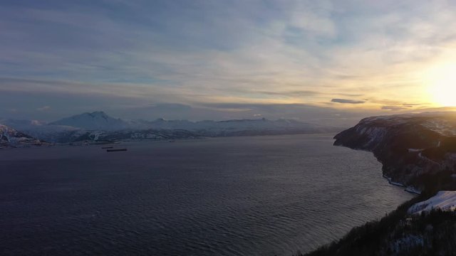 Ofotfjord Fjord and Mountains in Winter at Sunset. Nordland, Norway. Aerial View. Drone Flies Backwards