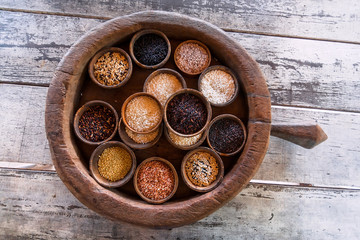 Some colorful rice sorts in wooden pot of asian kitchen. Selective focus basmati, jasmine, berry rice ready for cook. Popular food of South East Asia