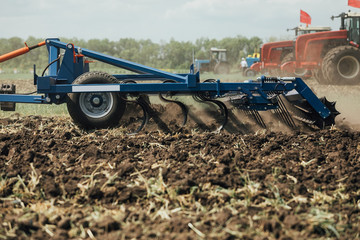 Fototapeta na wymiar the process of cultivating the soil with the plow during plowing test drive the tractor