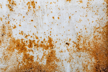 Metal surface with white paint that has passed temporary damage, a lot of formed, red rust. Textured background with traces of destruction and deformation