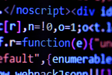Fototapeta na wymiar Close-up of minified javascript file. Computer programming source code for HTML website development.