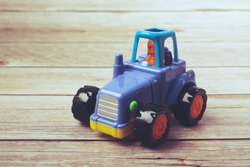 Plastic toy tractor isolated on white	
