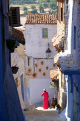 Local woman outdoors in the city of  Chefchaouen,Morocco.