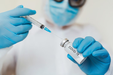 COVID vaccine. Competent medical worker spending his work time in the laboratory while researching coronavirus disease