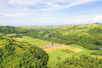 Fototapeta na wymiar River and green hills. Beautiful natural scenery of river in southeast Asia. The nature of the Philippines, Samar
