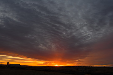  grain terminal silhouetted against living sky sunset