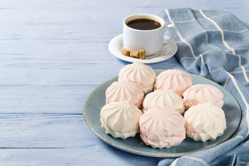 Good morning banner. Cup of coffee and homemade dessert zephyr, Zefir on light blue wood background. Top view. Food Photography with copy space