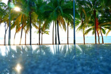 An empty table in front of an abstract blur background of coconut trees and the sea Can be used for rendering or editing your product, mock up for product display