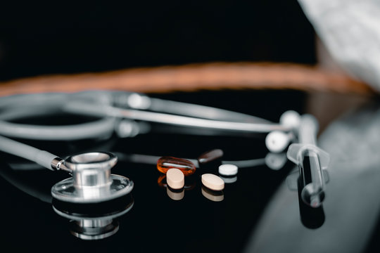 Stethoscope with medicine on table, Medicine and health care concept.