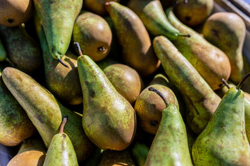 Green pears in a basket outside on the market