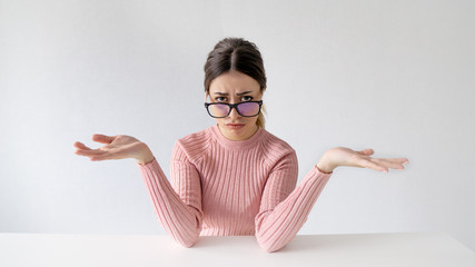 Annoyed disgruntled brunette girl in hipster glasses angrily asking reason of failure while...