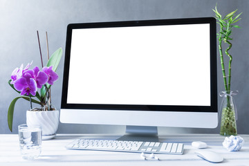 Computer all in one mockup, home and office workspace concept. Computer with white blank screen on work table front view. Copy space