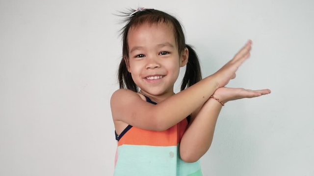 Portrait of Happy Asian child girl enjoying with dancing and sing song "baby shark" on white background. Concept of happy family and childhood.