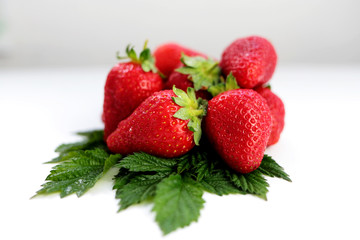 Juicy ripe strawberry closeup on a white background. Side view.
