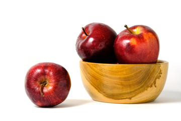 Group of green and red Apple fruit on a wooden bowl / basket isolated on white background