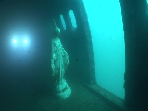 mother Mary statue underwater in an airplane wreck  ocean scenery