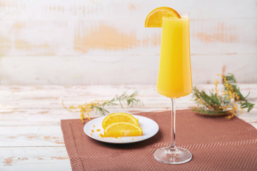 Glass of tasty mimosa cocktail on white table