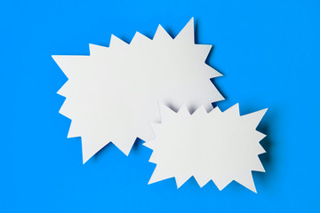 Blank promotional starburst sales banner on a bright blue background