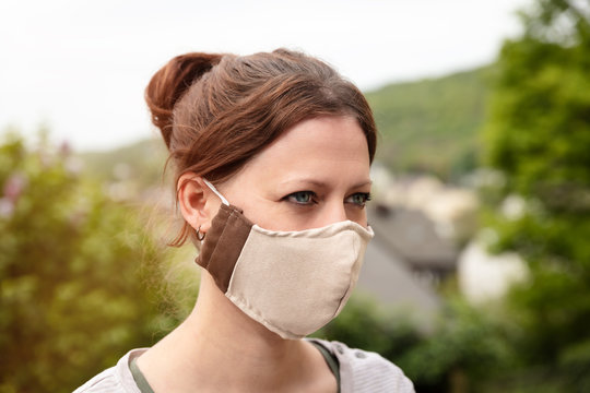Woman is wearing a homemade fabric cloth face mask, coronavirus and covid-19 prevention and protection