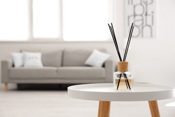 Reed diffuser on table in living room