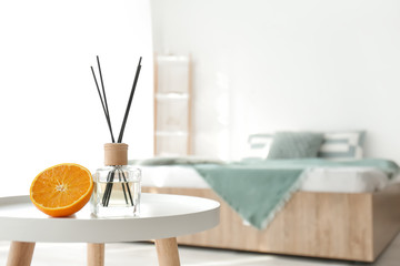 Reed diffuser on table in bedroom