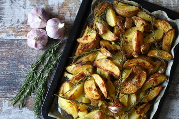 Baked Potato with Rosemary and Garlic. Cooking at home.