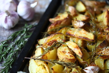 Baked Potato with Rosemary and Garlic. Cooking at home.