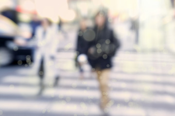 Blurry abstract background image of people walking on busy street
