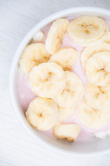 Naklejka na ściany i meble Banana Yogurt. Oatmeal with banana. Granola for breakfast with banana top view.