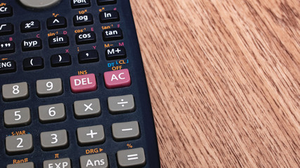 Engineering calculator on a wooden table closeup